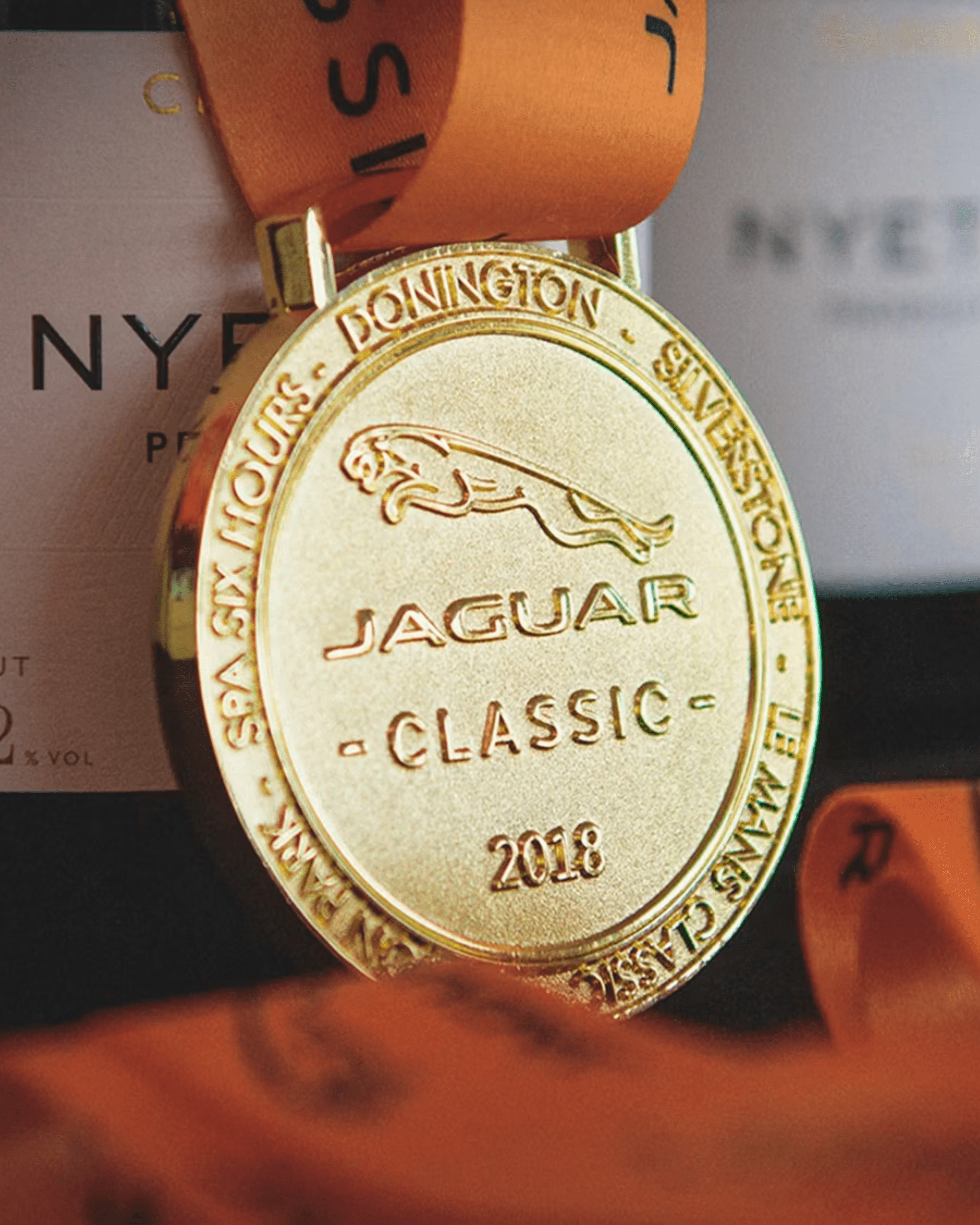 Gold Jaguar Classic 2018 medal with orange ribbon and race circuit names.