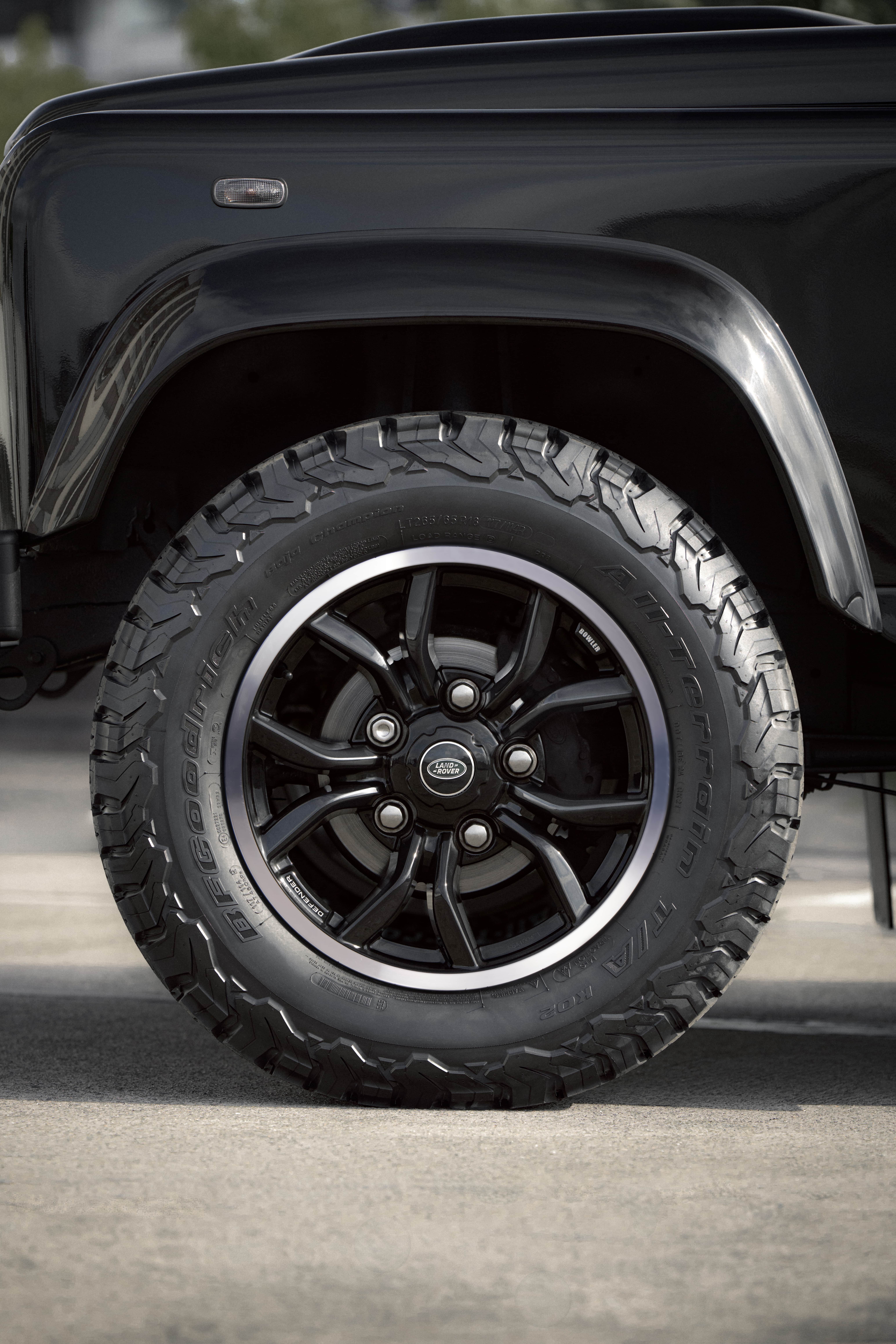 Close-up of rear off-road tire on a black Defender.