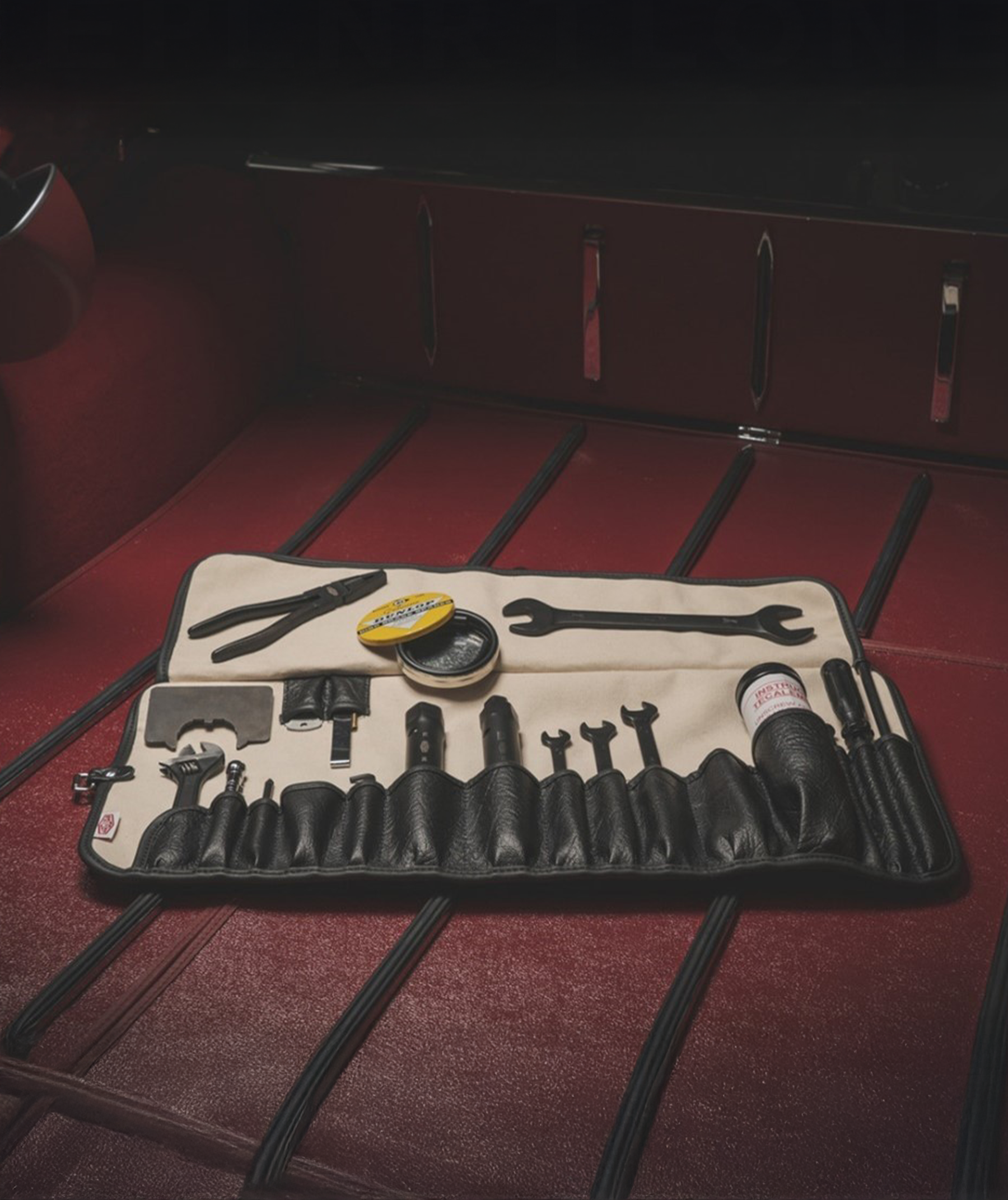 E-Type toolkit laid out on red surface with tools, RENOLIT tin, and KONTAKT container.